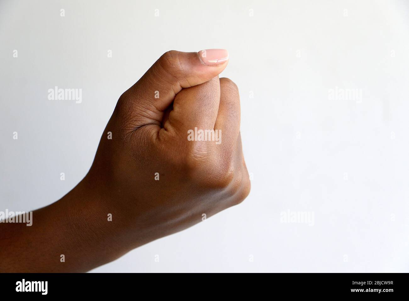 Isolated black african indian hand clenched in a fist symbolizing black power Stock Photo