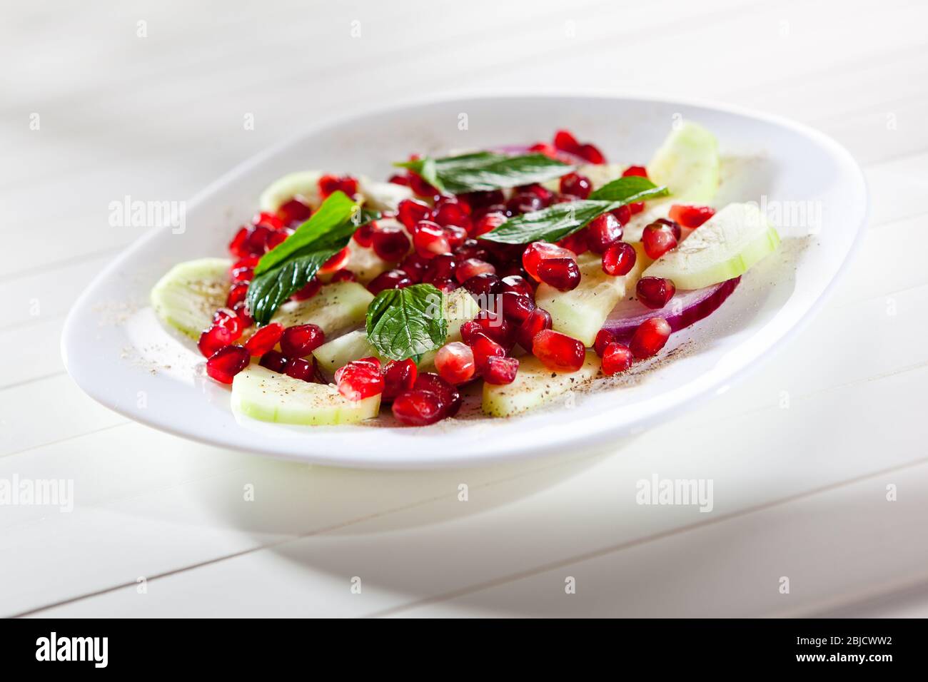 Cucumber onion and pomegranate fresh salad for healthy nutrition Stock Photo