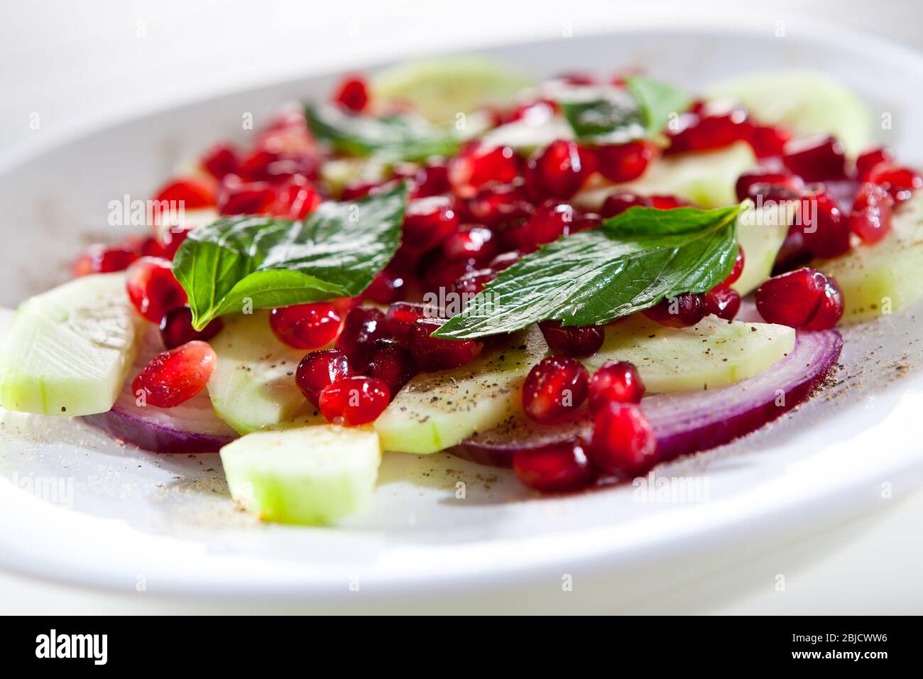 Cucumber onion and pomegranate fresh salad for healthy nutrition Stock Photo