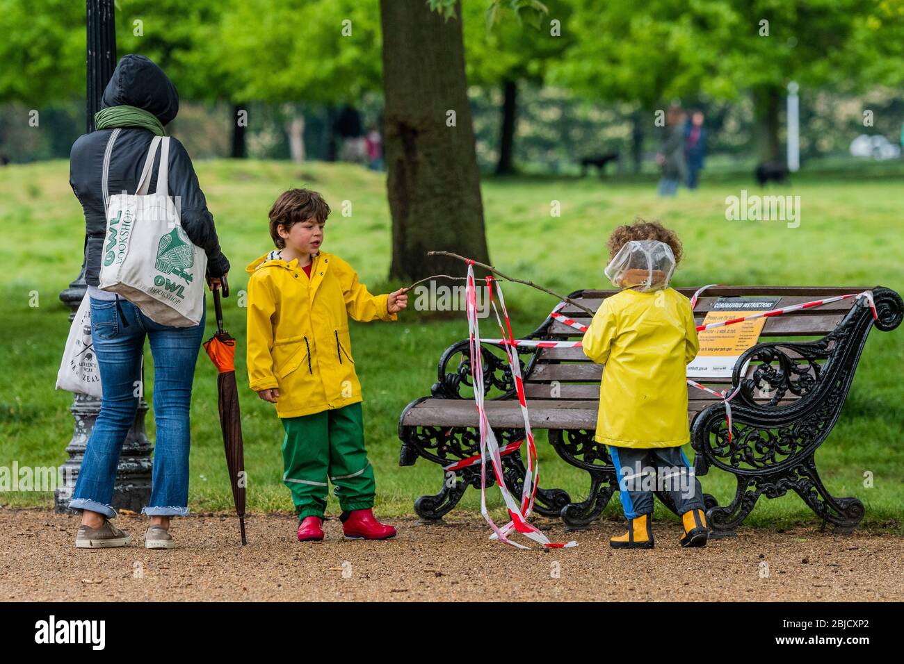 London Uk 29th Apr Children Playing With Banners Made From Found Sticks And Bits Of Tape Are Read The Warning Instructions On A Taped Bench An Alternative Use For The Tape London Uk 29th Apr Children Playing With Banners Made From Found Sticks And Bits Of Tape Are Read The Warning Instructions On A Taped Bench An Alternative Use For The Tape