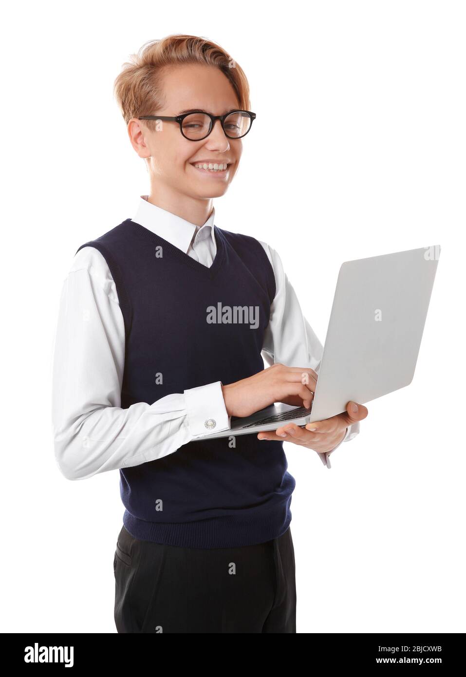 Teenage boy holding laptop on white background Stock Photo - Alamy