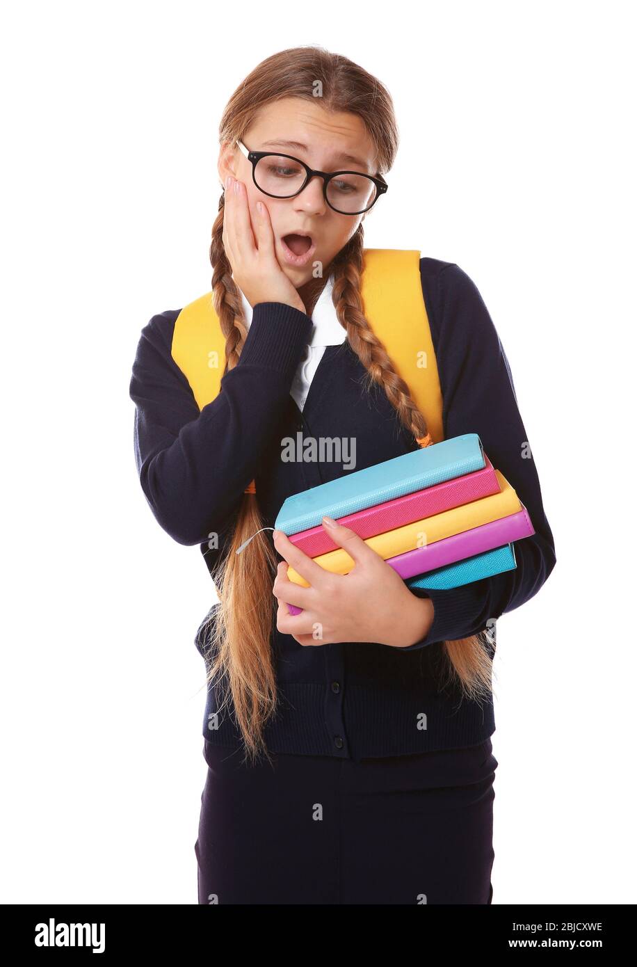Teenage girl with backpack holding books on white background stock