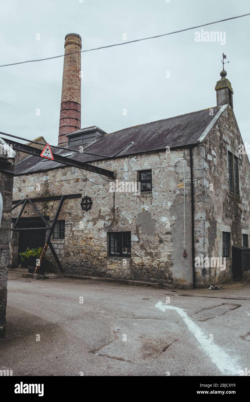 Brora, Scotland / March 22 2018: The old stone Brora distillery building, rugged territory, fine whiskey, Scotland, UK Stock Photo