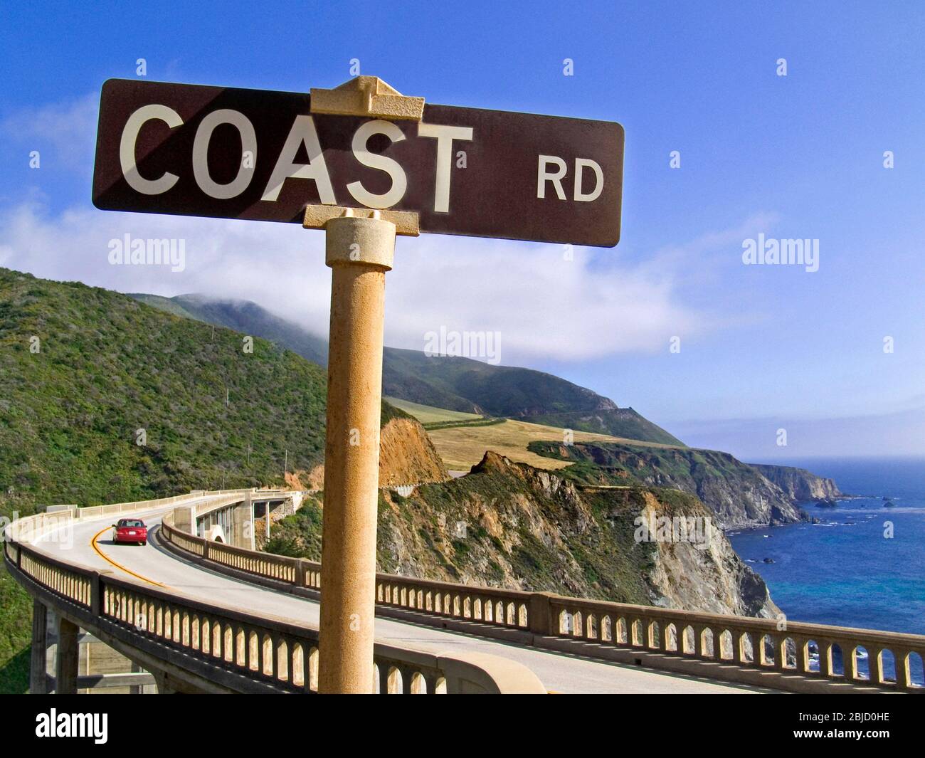 BIXBY BRIDGE Highway 1 ‘Coast road’ sign and red car behind at Big Sur Monterey California USA Stock Photo