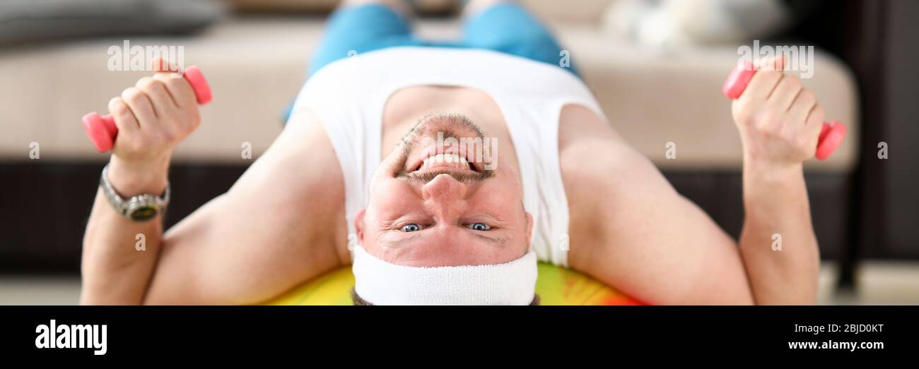 Man at home during quarantine goes in for sports Stock Photo