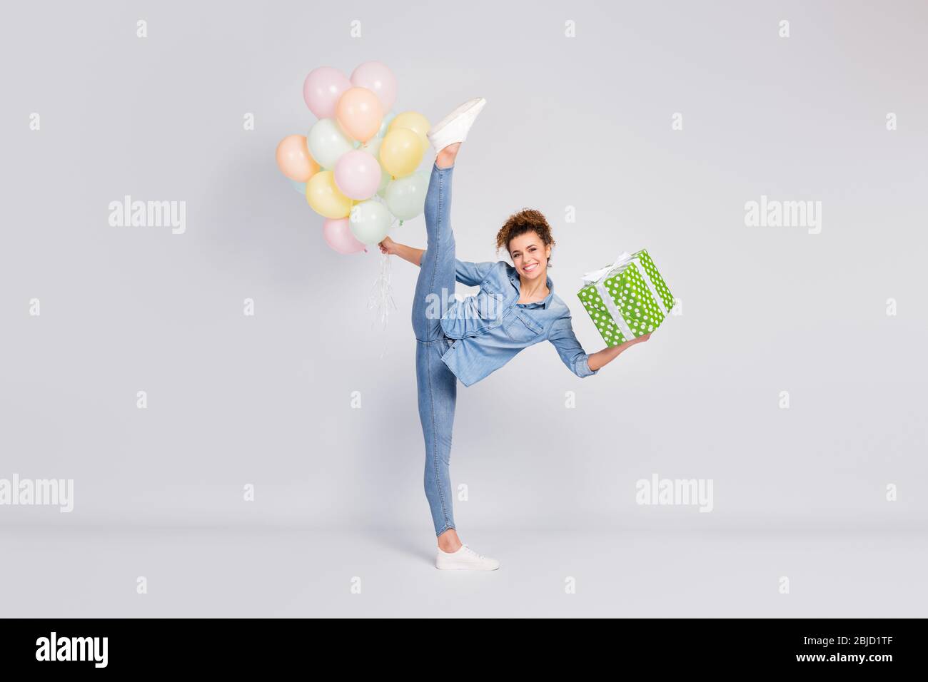 Full size photo of attractive lady raise leg up stand cross twine show