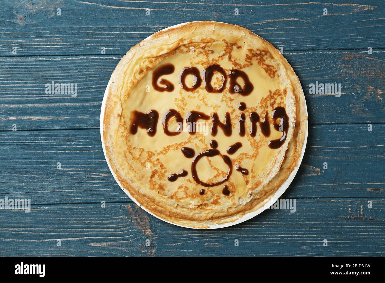 Words GOOD MORNING written on pancakes with chocolate, wooden ...