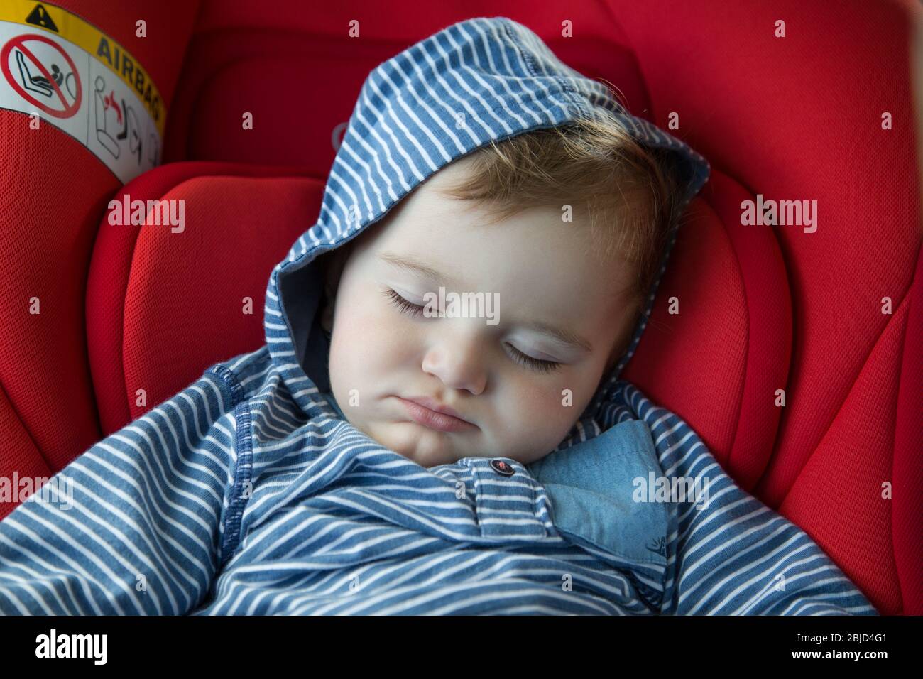 Baby boy sleeps in the car seat Stock Photo Alamy