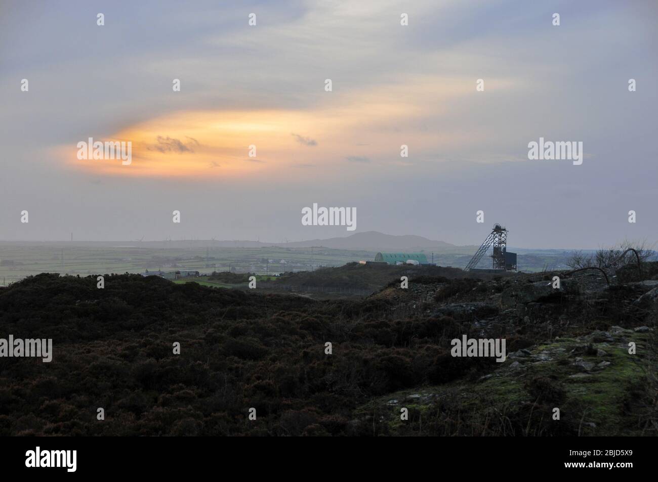 Around the UK - A  silhouette of a more recent pit head adjacent to Parys Mountain, Anglesey Stock Photo