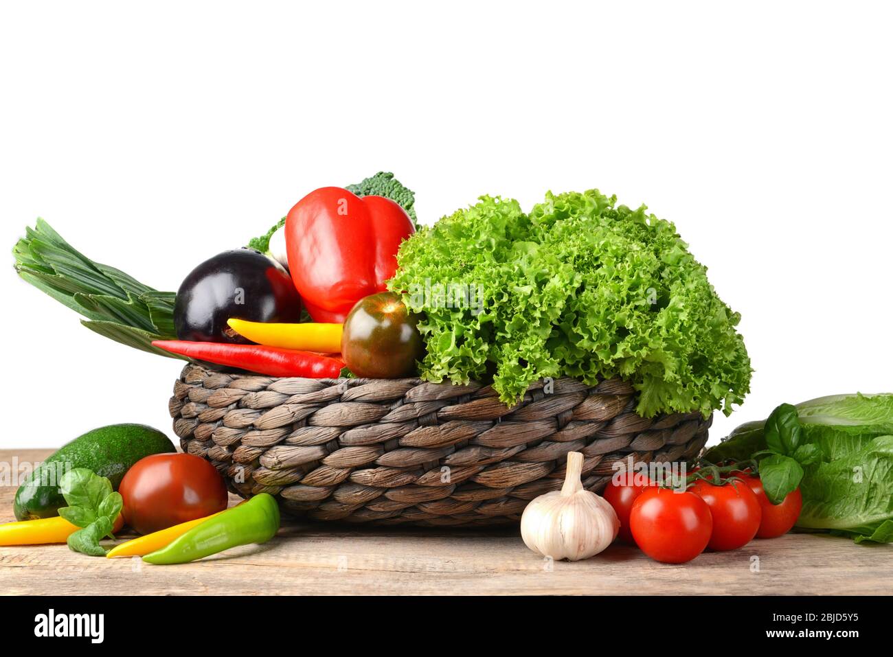 Fresh vegetables in wicker basket on table Stock Photo - Alamy