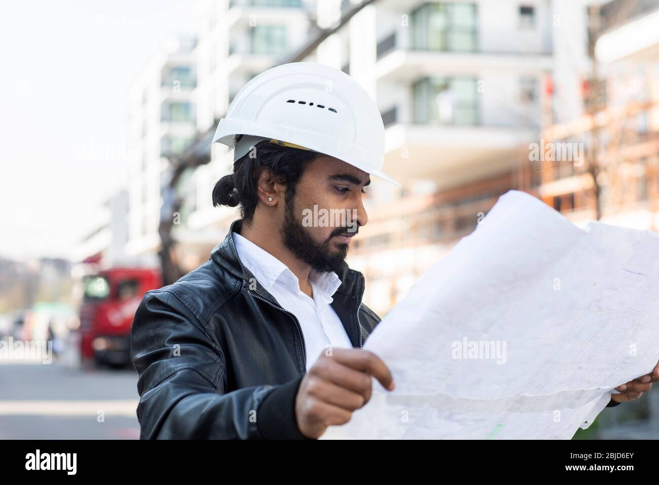civil engineer working outside with helmet and plan Stock Photo Alamy