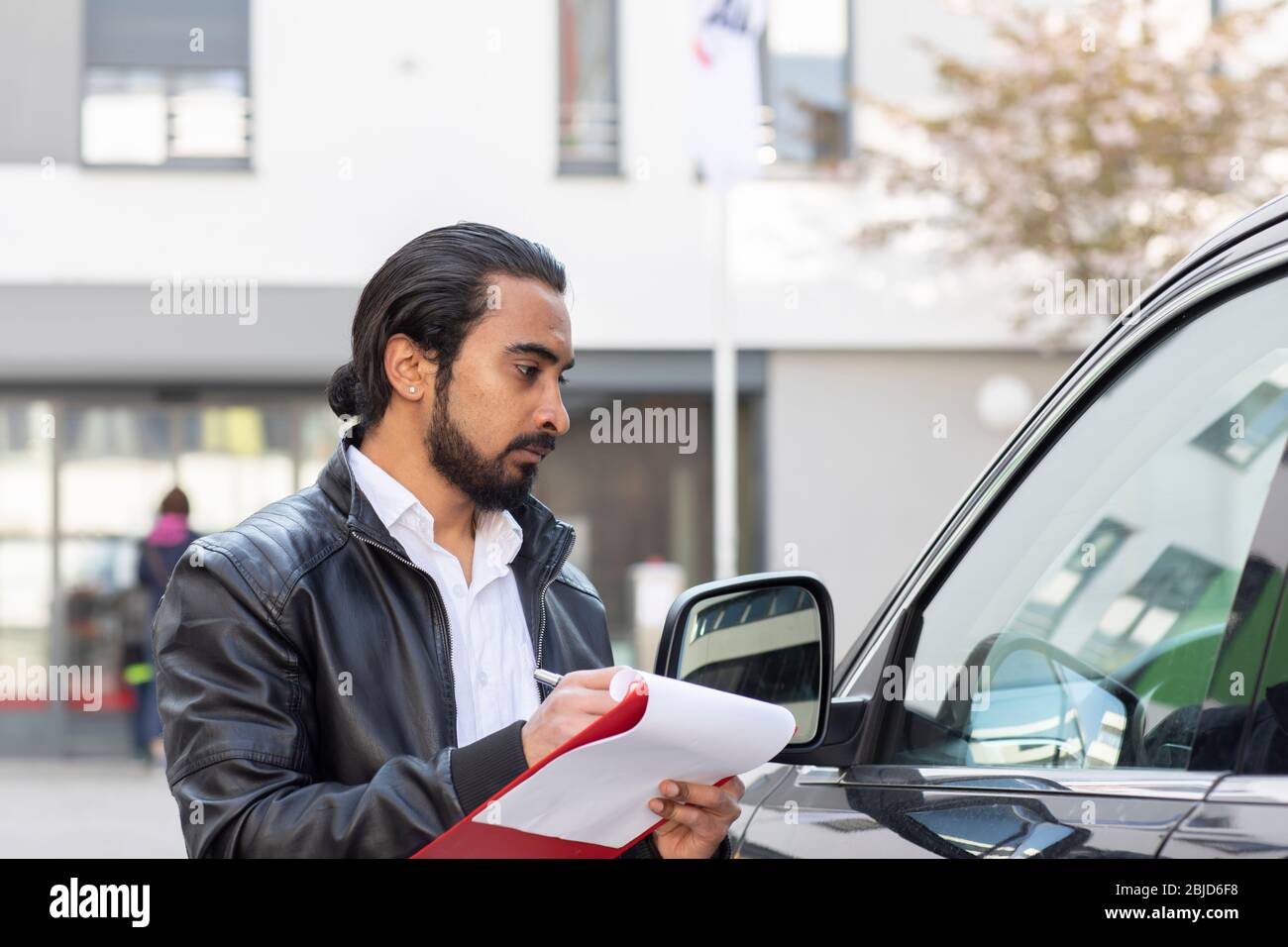 Service technician working in a car rental with protocol Stock Photo