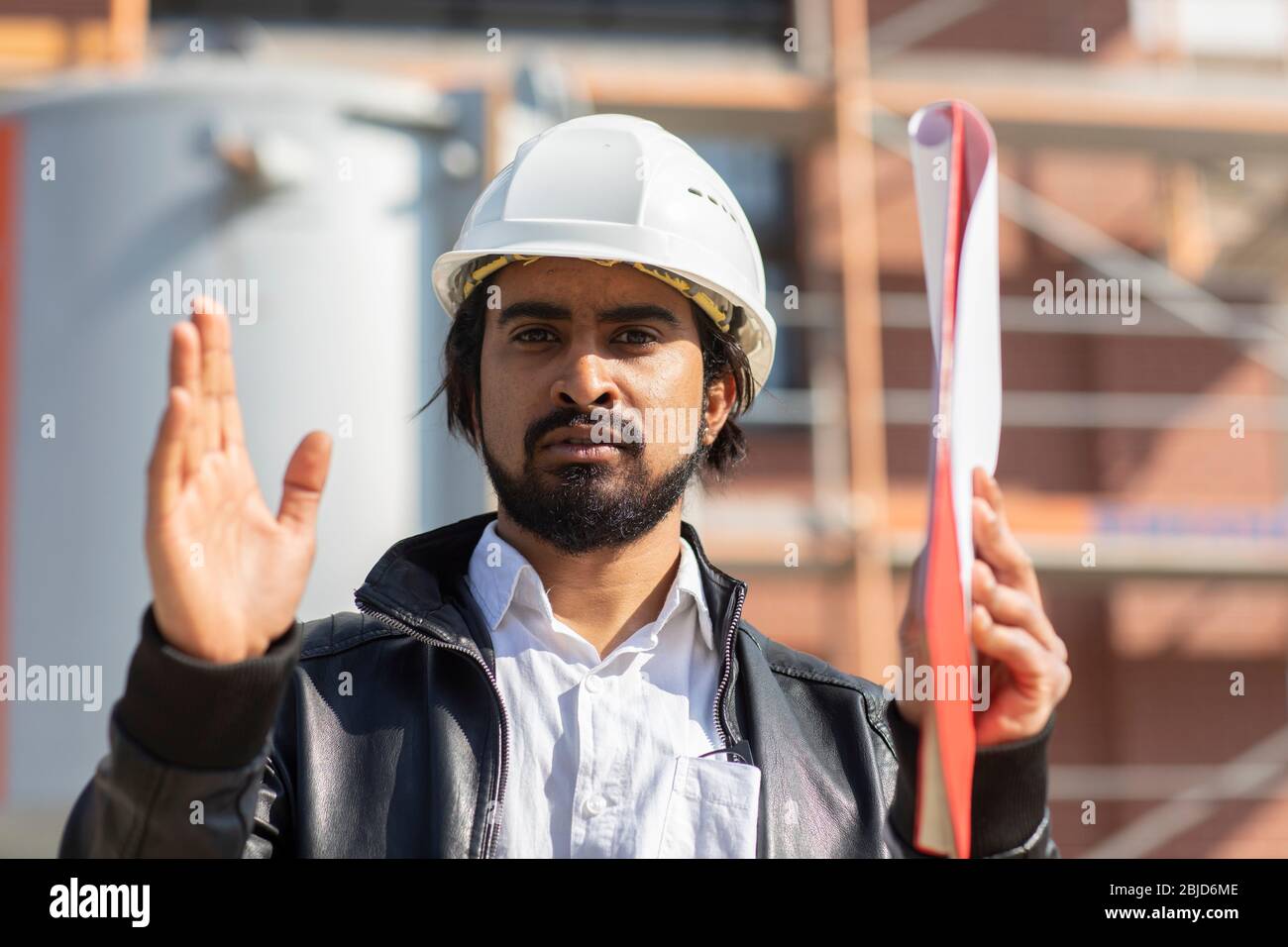 civil engineer working outside with helmet and plan Stock Photo Alamy
