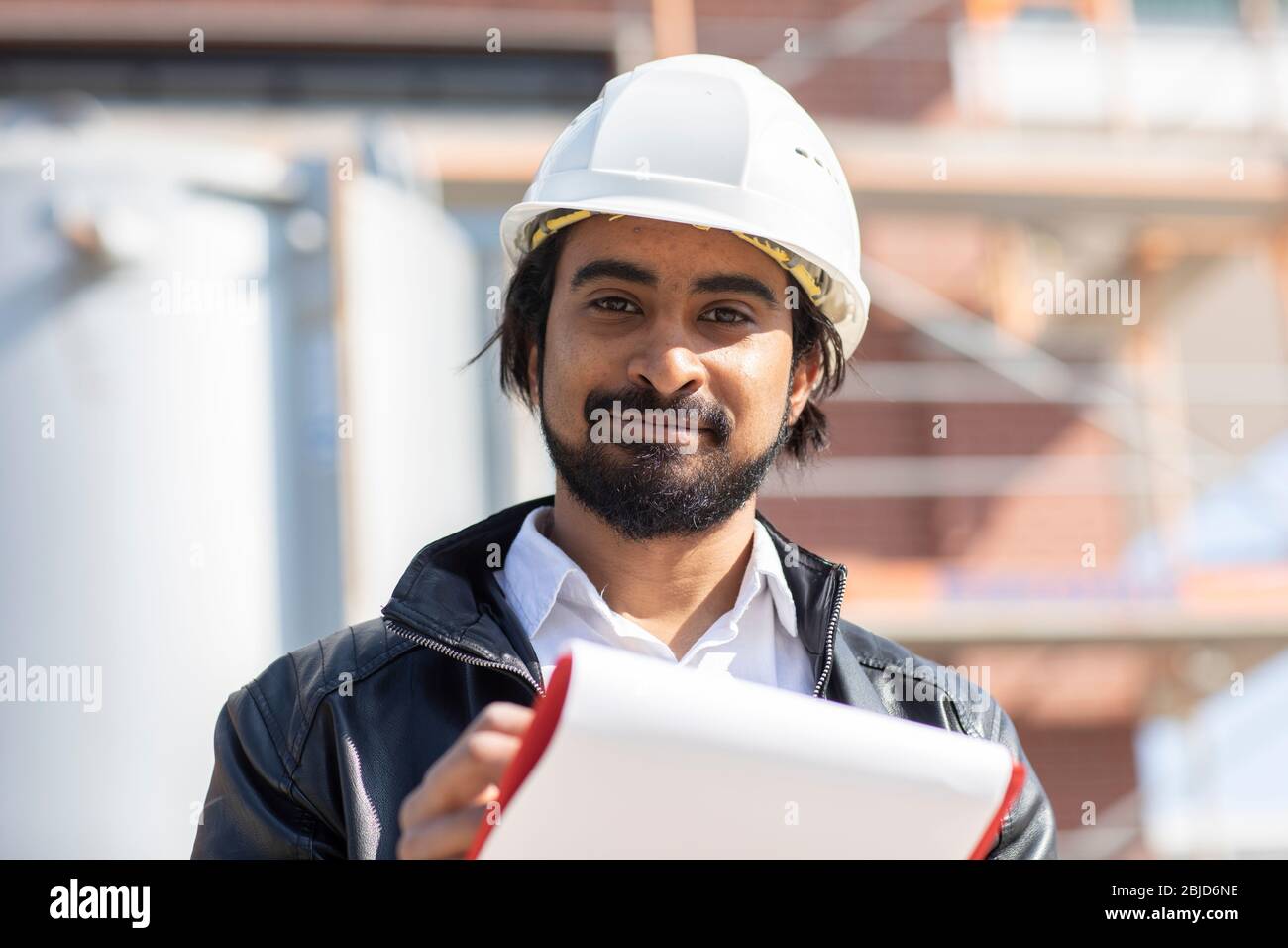 civil engineer working outside with helmet and plan Stock Photo Alamy