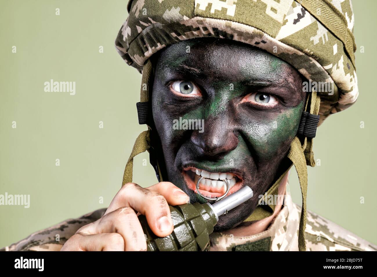 Close up view of soldier pulling safety pin out of fragmentation