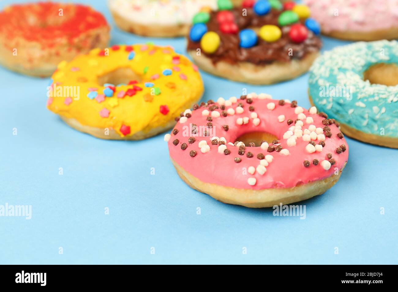 Glazed donuts on color background, closeup Stock Photo - Alamy