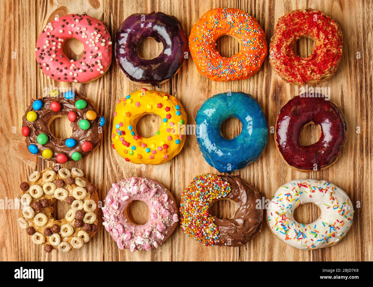 Glazed donuts on wooden background Stock Photo - Alamy