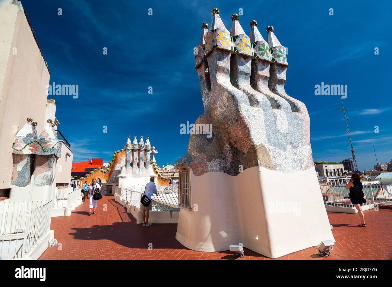 Barcelona, Spain - September 19, 2014: Rooftop of the house Casa Batllo - House of Bones designed by Antoni Gaudi. Ceramic tiles, with tower and bulb. Stock Photo