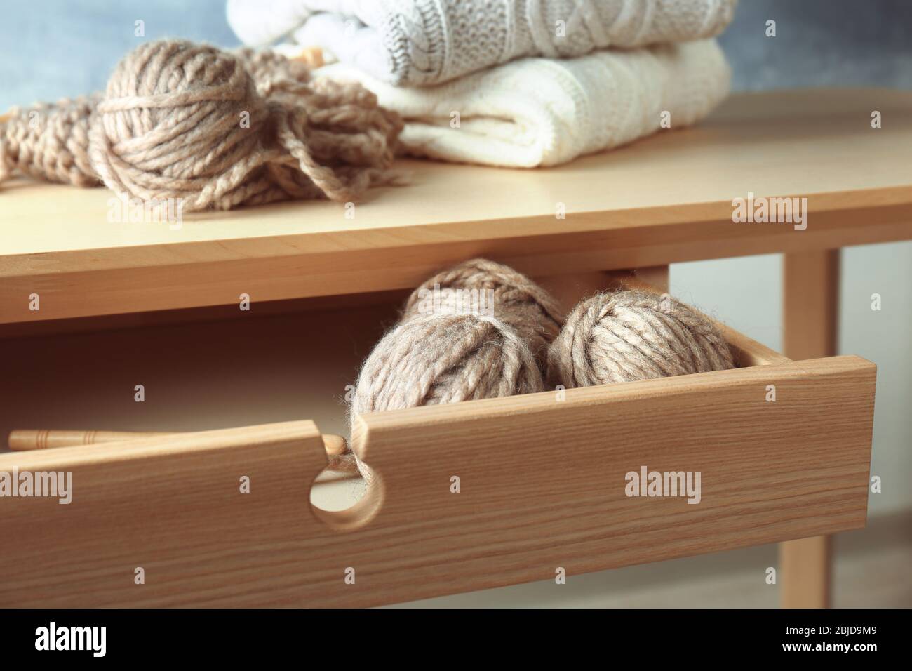 Balls of knitting yarn in table drawer Stock Photo Alamy