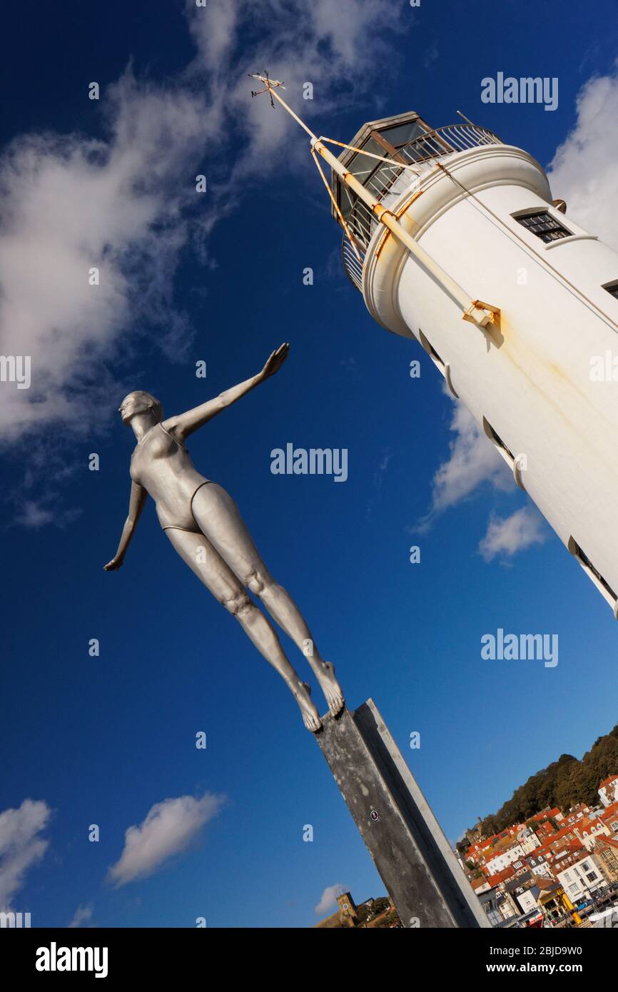 Scarborough lighthouse tower with 'diving belle' sculpture in foreground. Yorkshire England UK Stock Photo