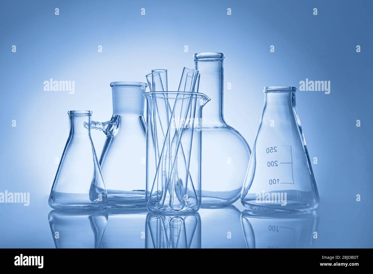 Test tubes and flasks on colour background Stock Photo - Alamy