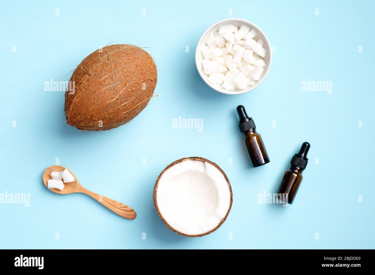 Coconut aromatherapy massage oil with half of coconut and sliced ...