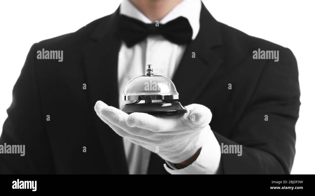 Bellboy holding bell on his hand, close up Stock Photo - Alamy