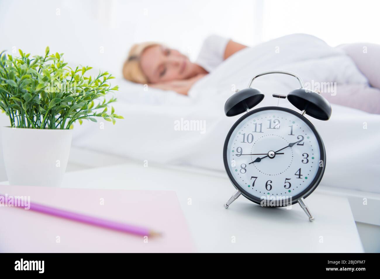 Close-up portrait of her she nice attractive woman lying in bed sleeping spending day weekend day-off everyday alarm bell ringing early in modern Stock Photo