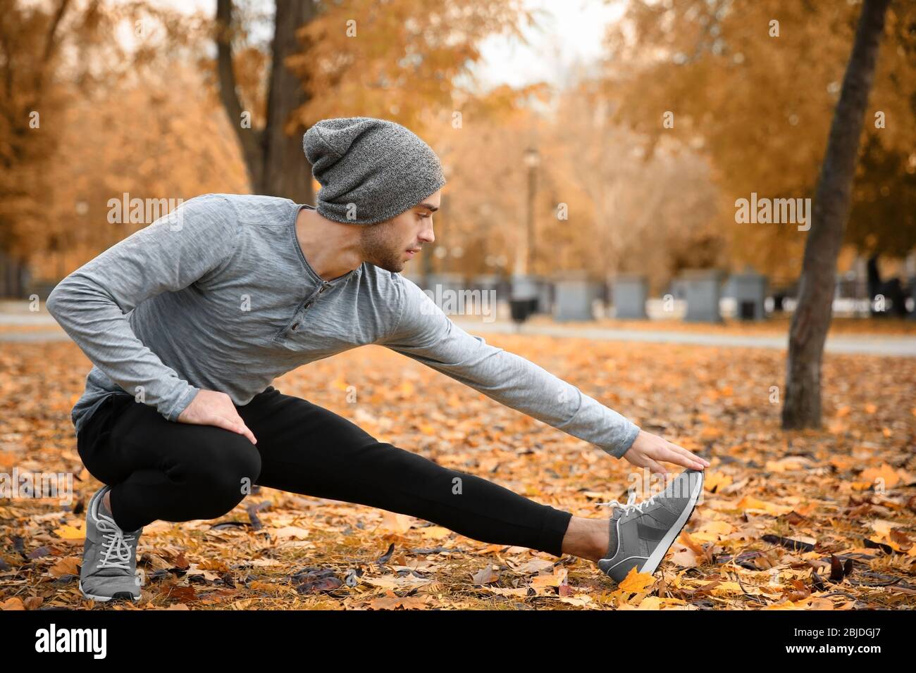 Handsome young man stretching hi-res stock photography and images - Alamy