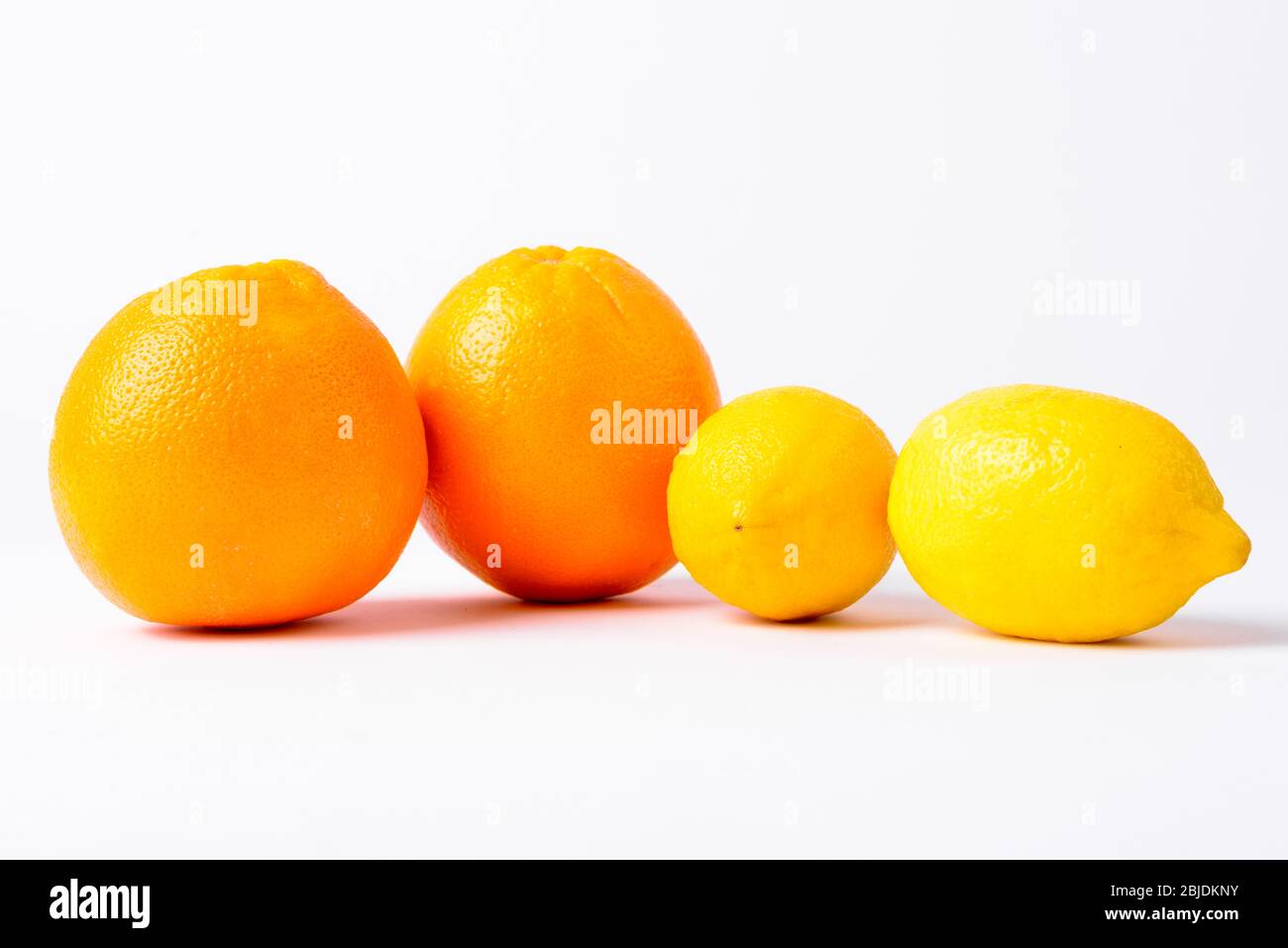 Portrait Of Oranges And Lemons Against White Background Stock Photo Alamy