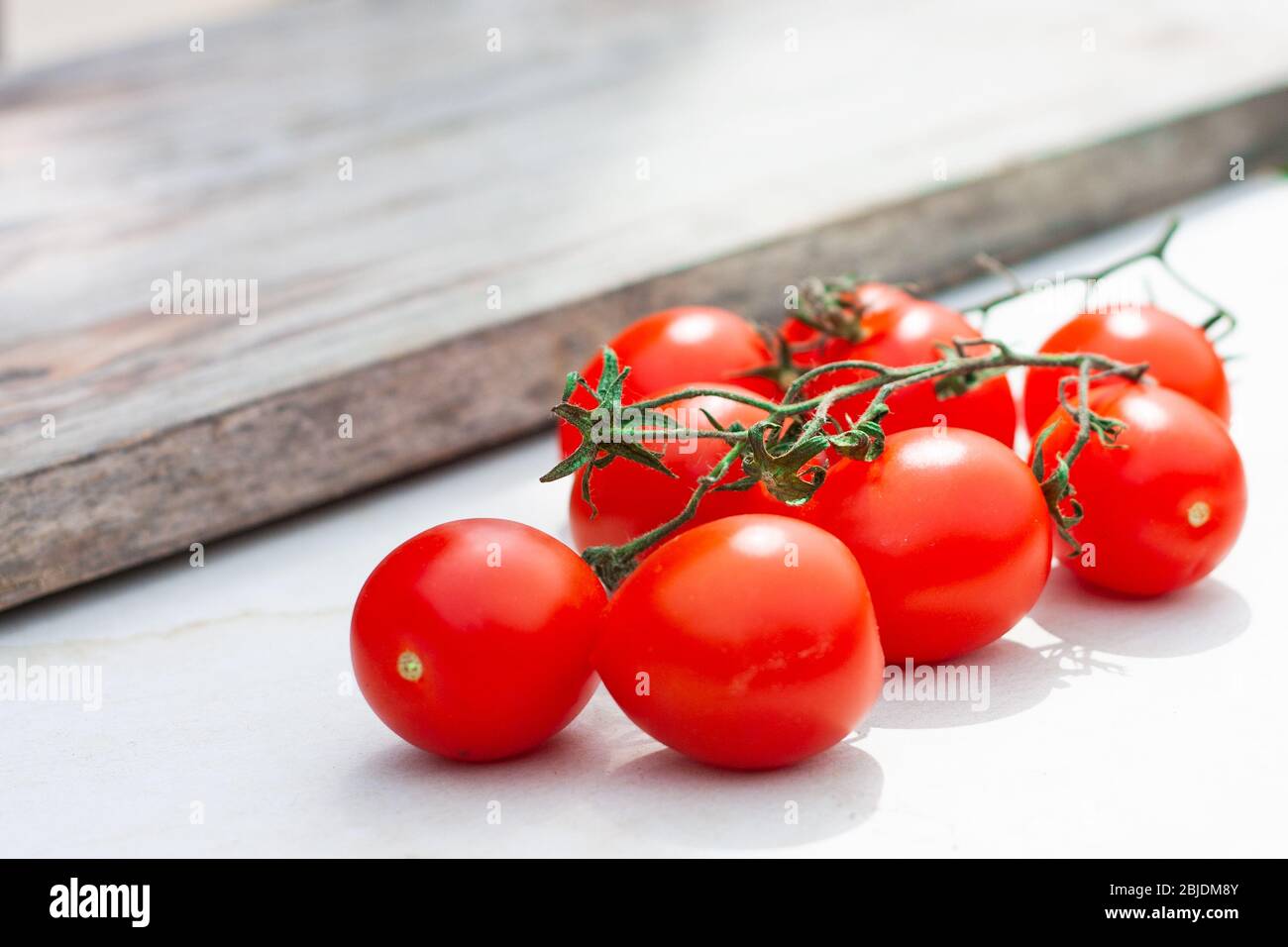 Piccadilly tomato bunch. Fresh juicy sweet tomatoes for traditional Mediterranean cuisine. Selective focus. Stock Photo