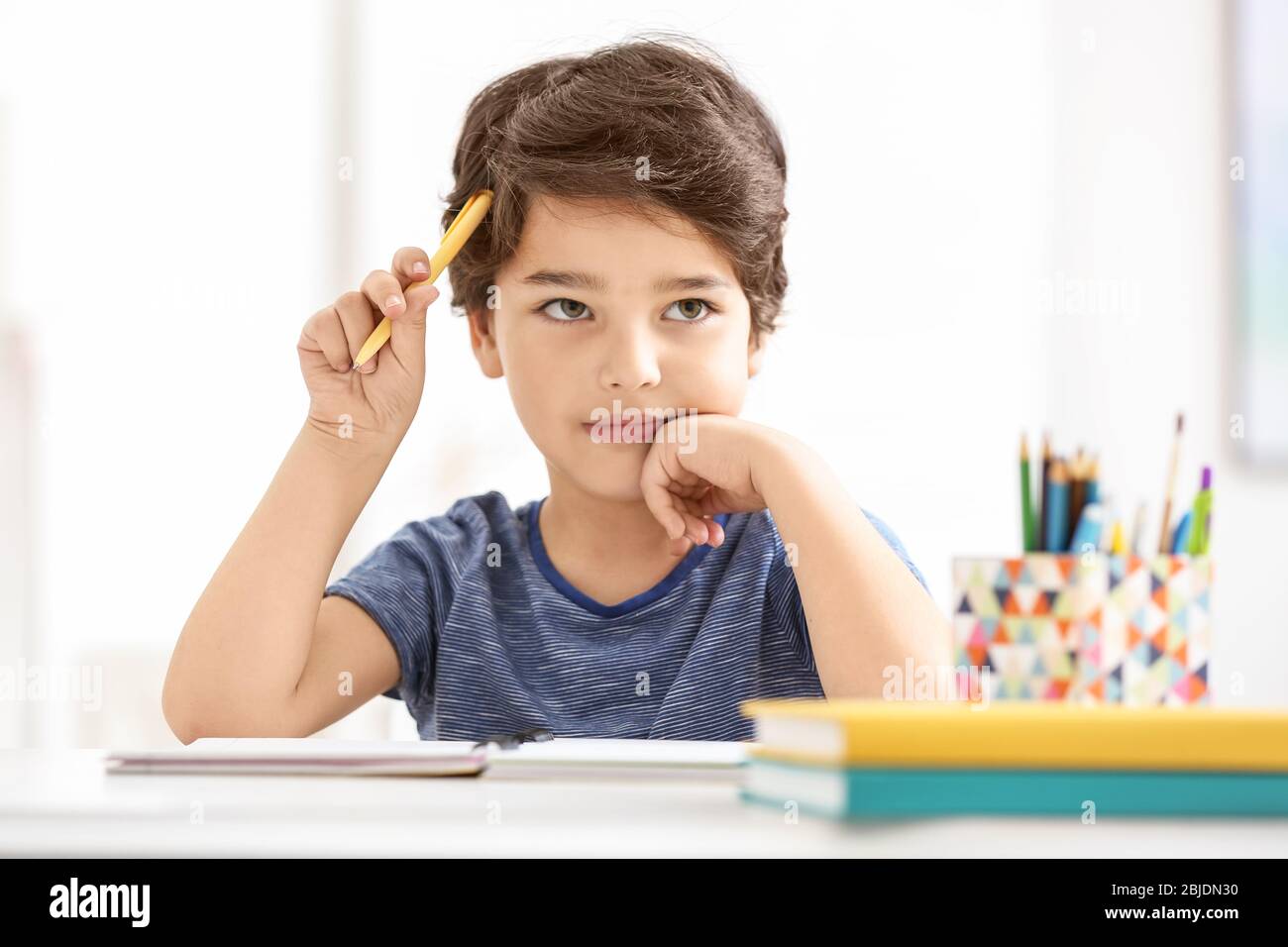 Cute little boy thinking about something, on blurred background Stock ...