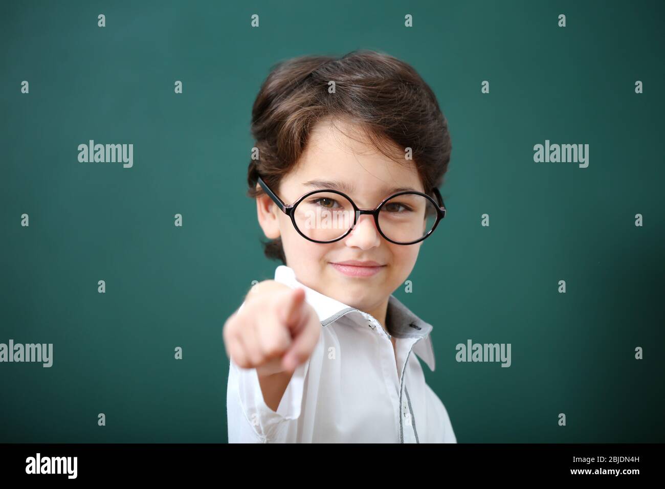Cute little boy in glasses on green background Stock Photo Alamy