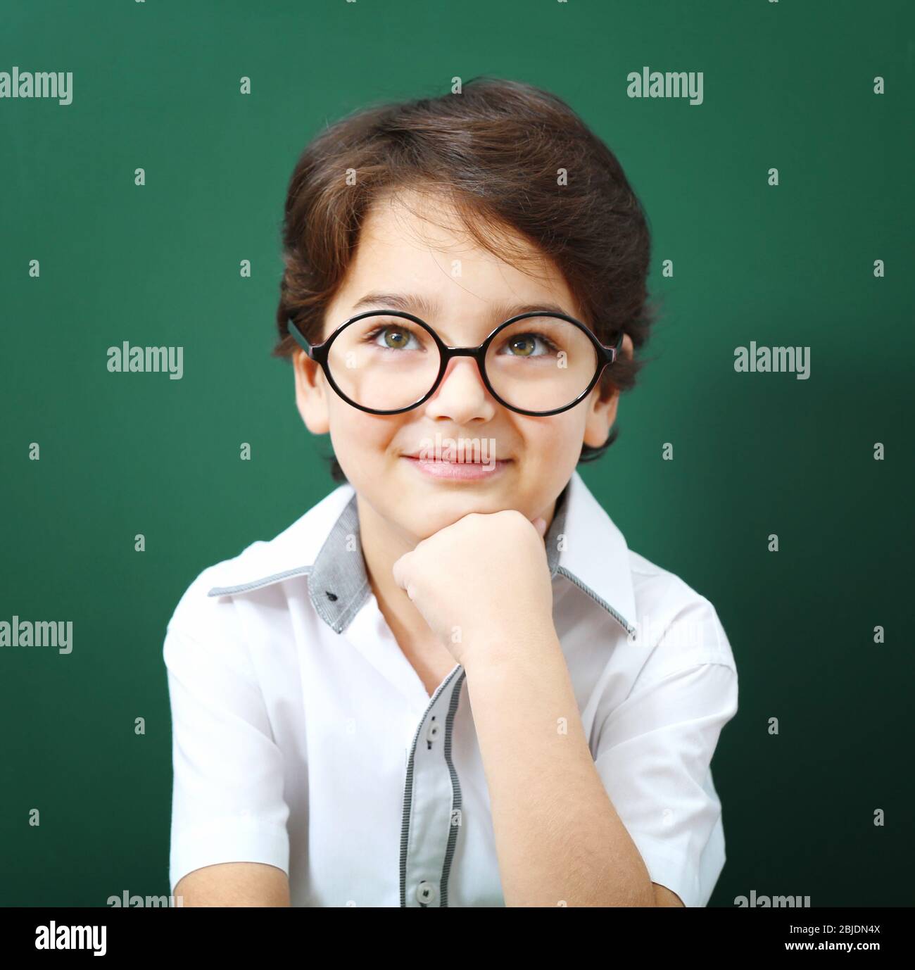 Cute little boy in glasses on green background Stock Photo Alamy