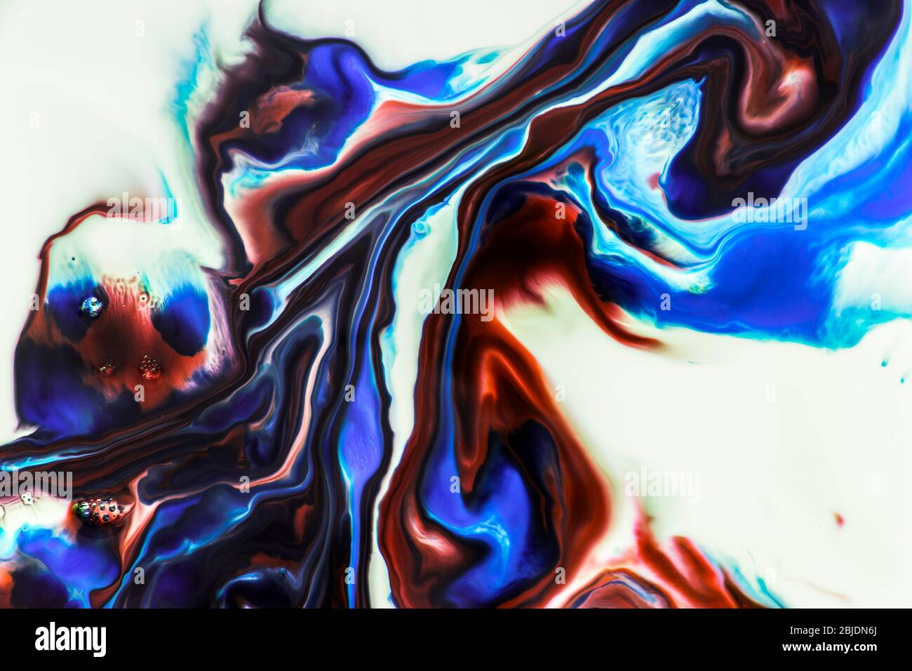 Background of milk and colored diluted paints in it Stock Photo