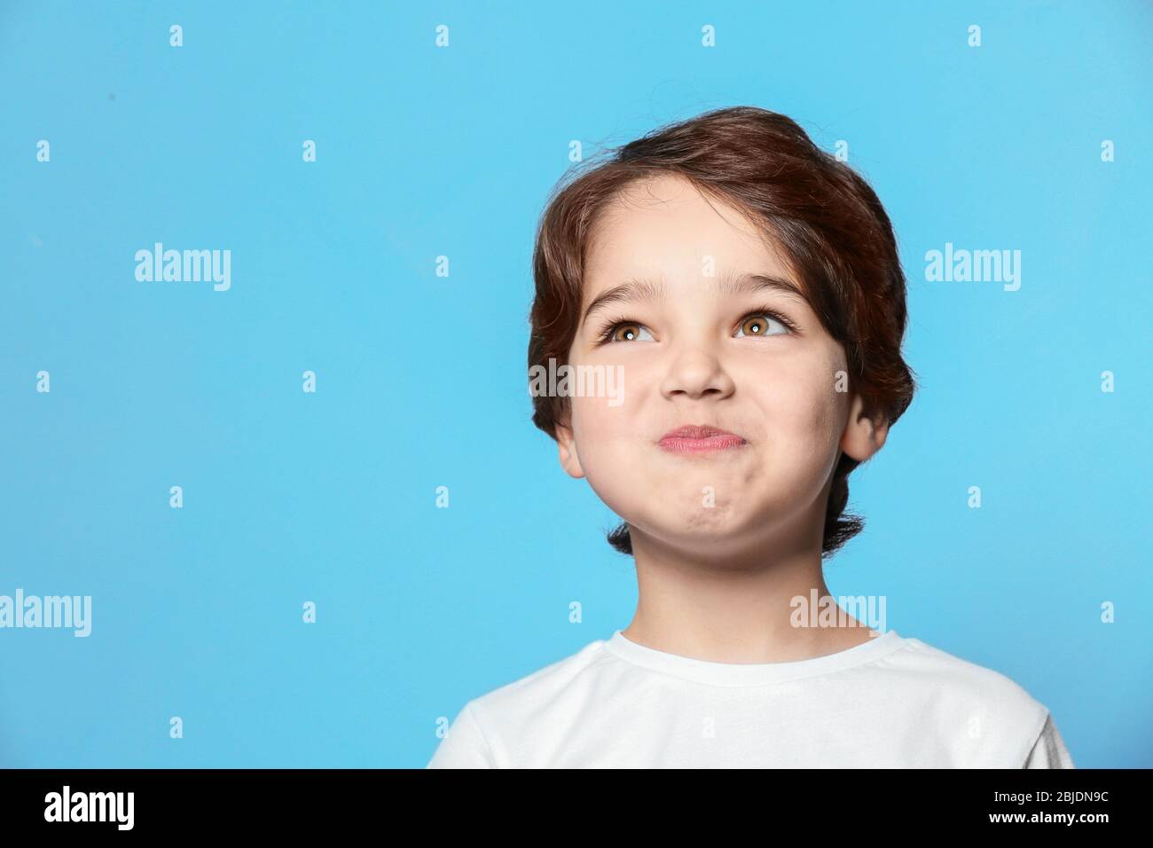 Little boy on blue background hi-res stock photography and images - Alamy