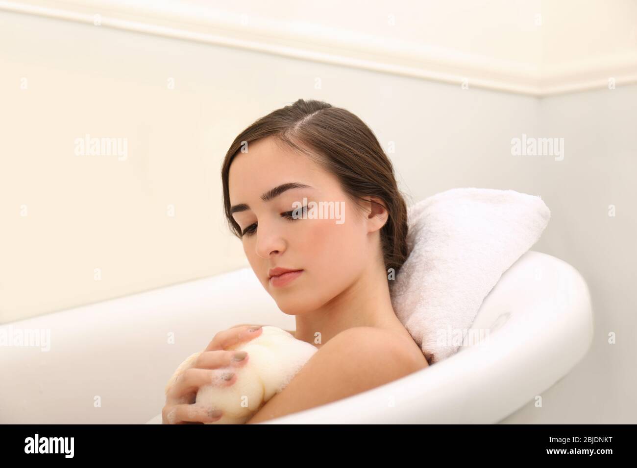 Young beautiful woman taking bubble bath Stock Photo - Alamy