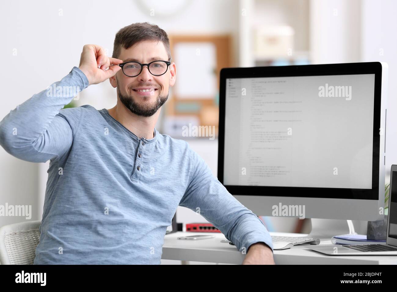 Handsome young programmer working in office Stock Photo