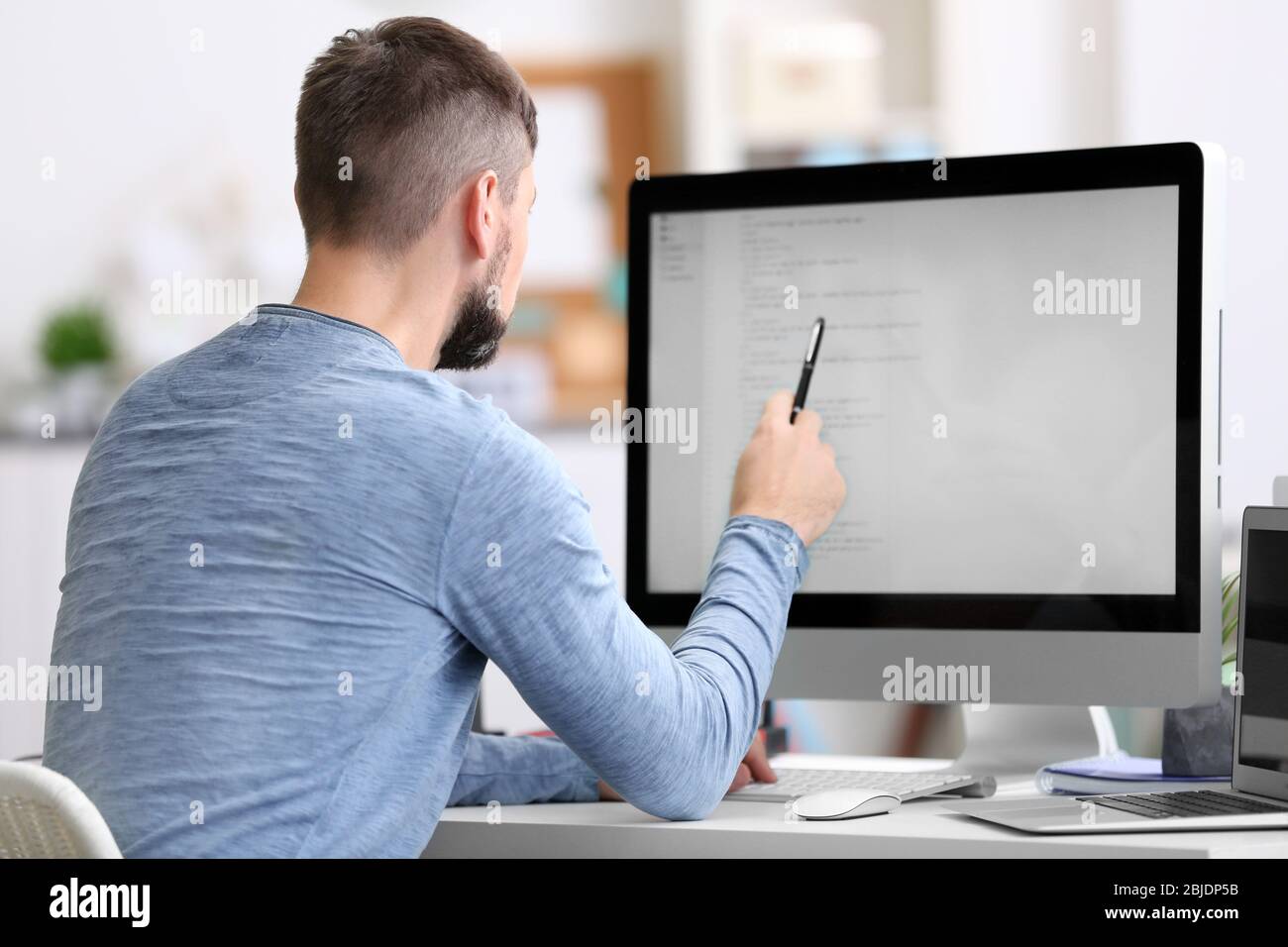 Handsome young programmer working in office Stock Photo