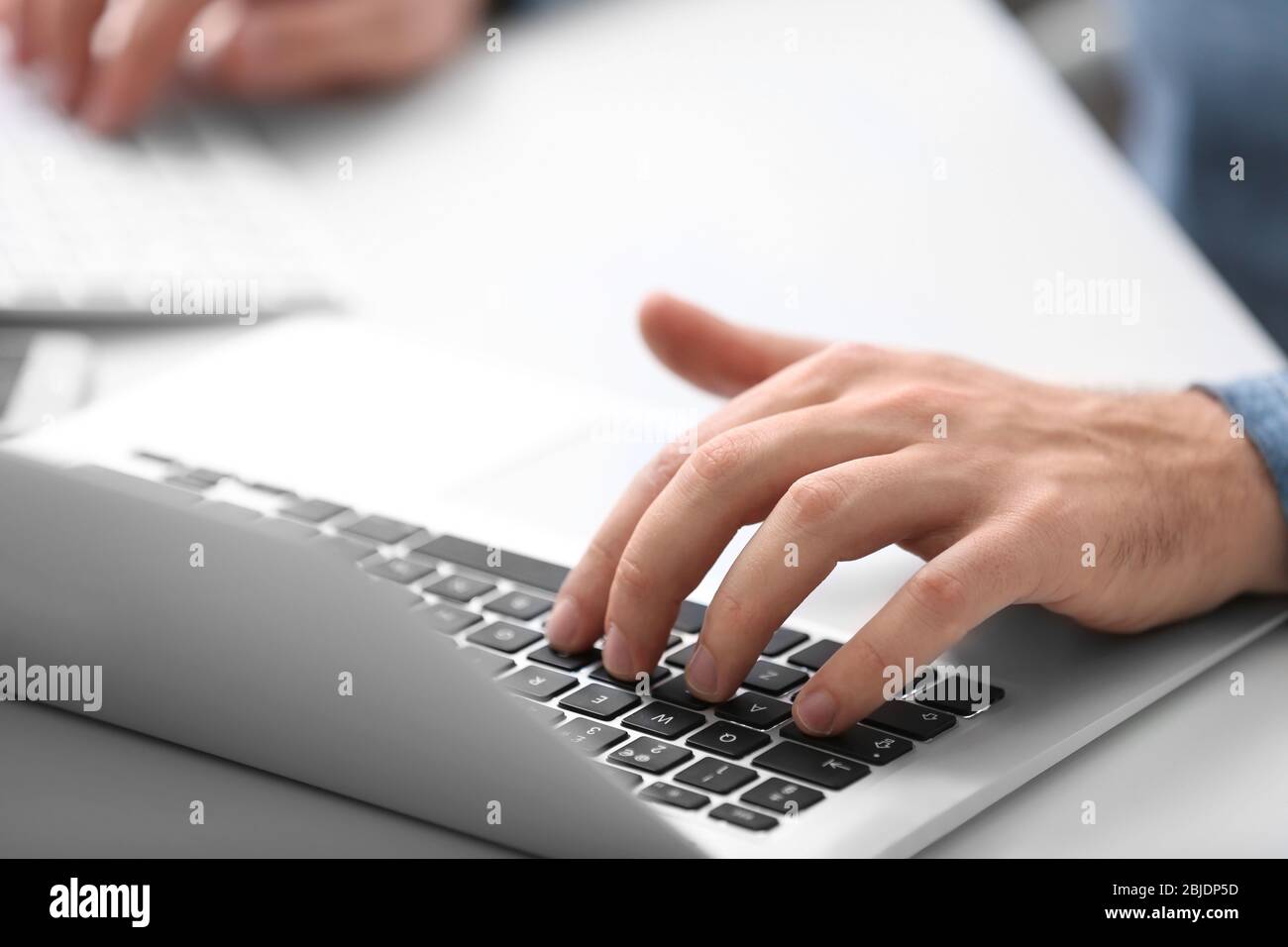 Programmer working with laptop in office, closeup Stock Photo