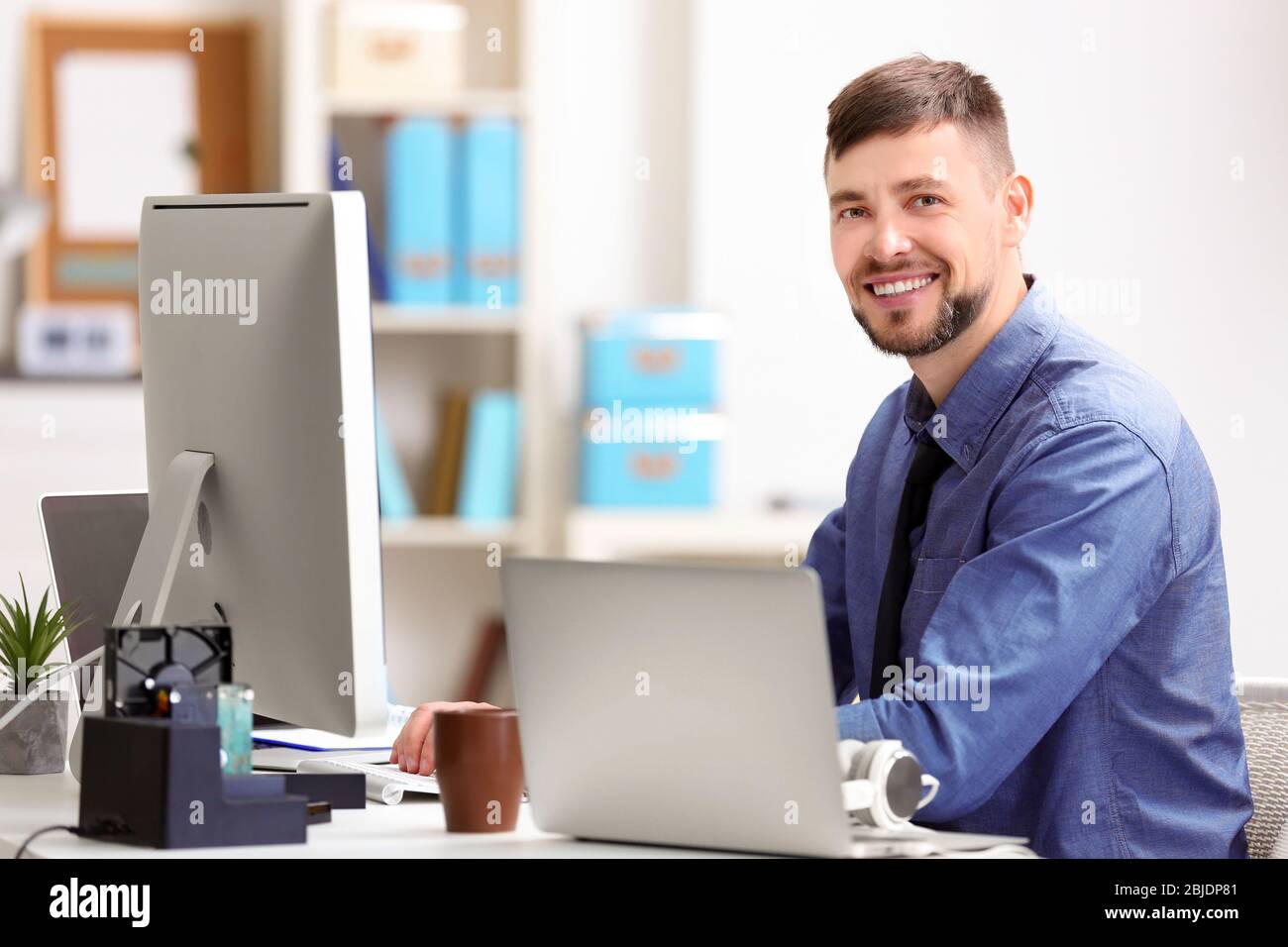 Handsome young programmer working in office Stock Photo