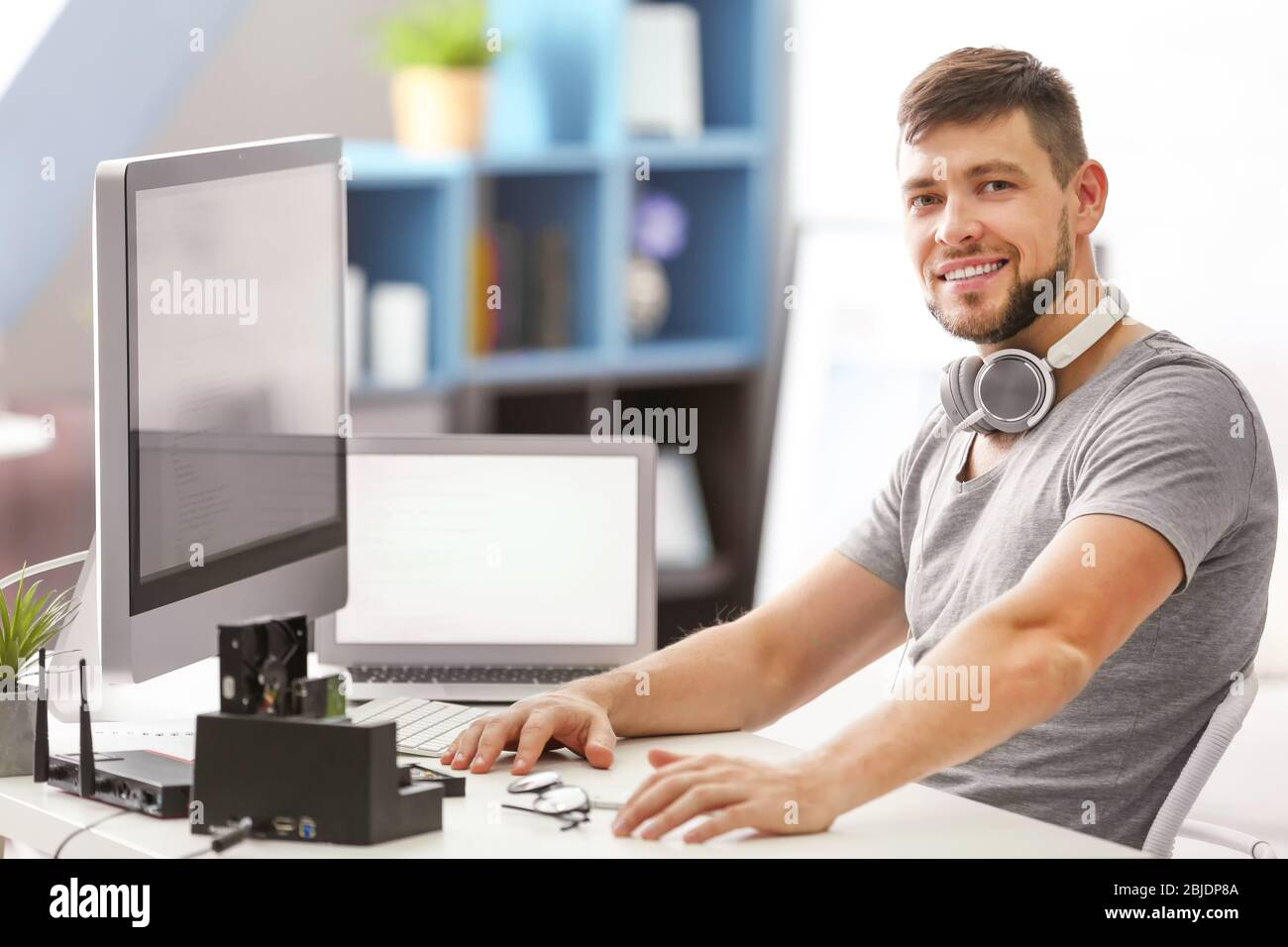 Handsome young programmer working at home Stock Photo