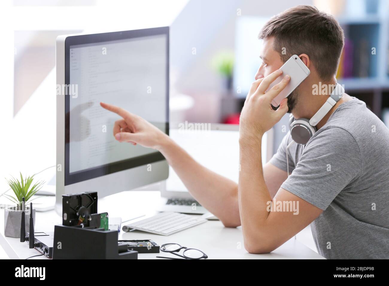 Handsome young programmer working at home Stock Photo