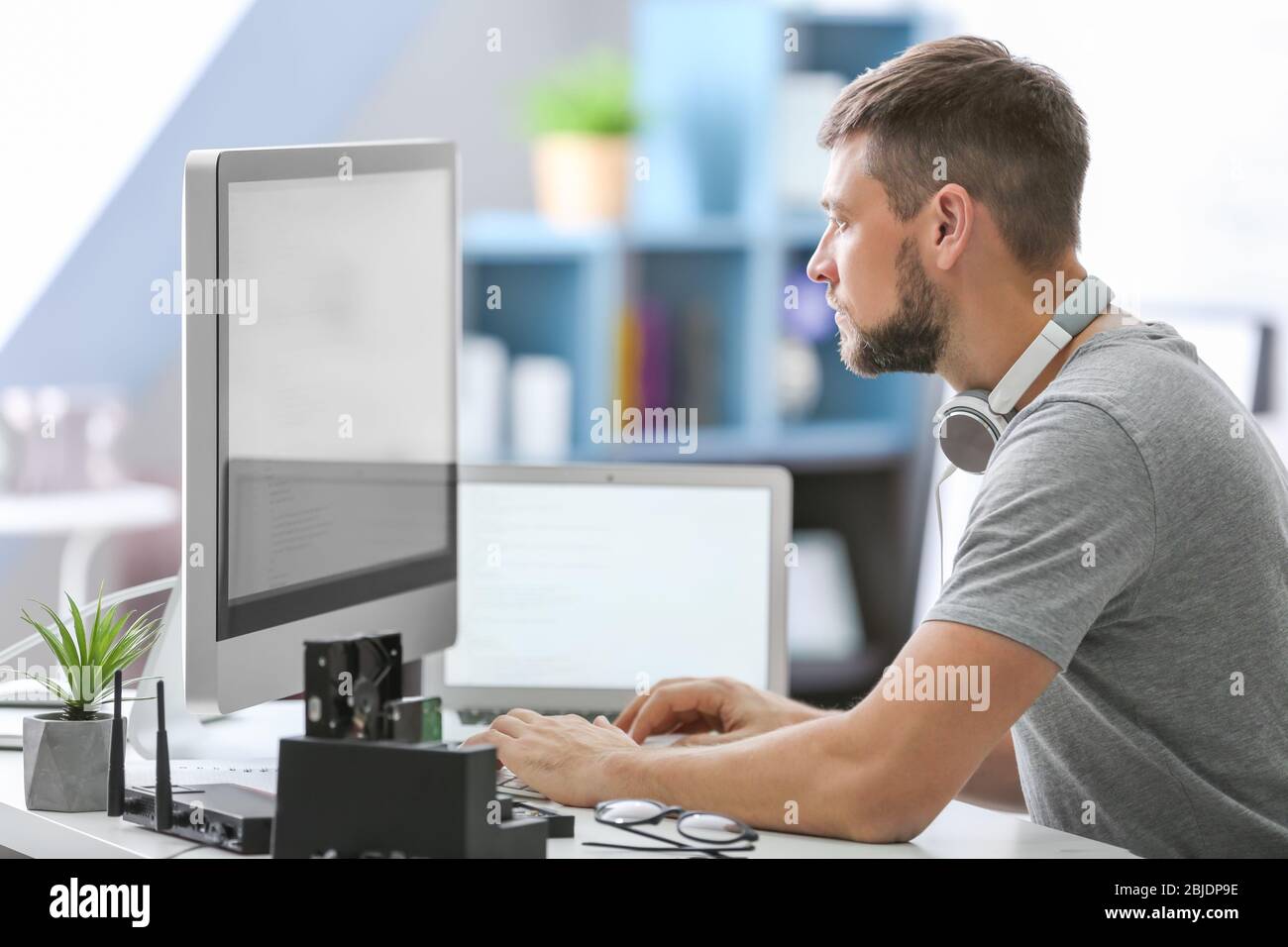 Handsome young programmer working at home Stock Photo