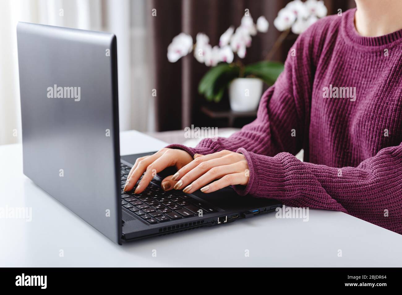 Woman working or learning from home using laptop. Freelancer have remote work, online education, work on maternity leave. Female hands typing on Stock Photo