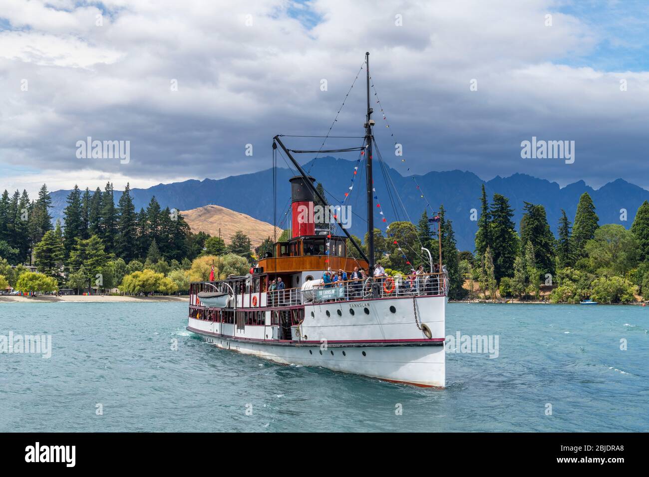 The steamship TSS Earnslaw approaching Steamer Wharf, Lake Wakatipu, Queenstown, New Zealand Stock Photo