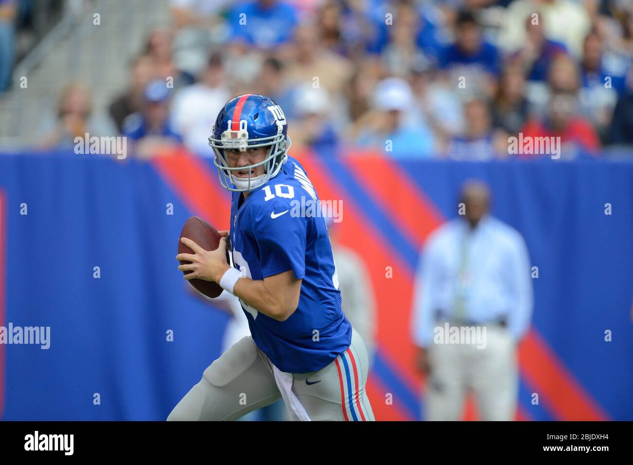 16 September 2012: New York Giants quarterback Eli Manning (10) rolls out of the pocket looking to pass during a week 2 NFL NFC matchup between the Ta Stock Photo