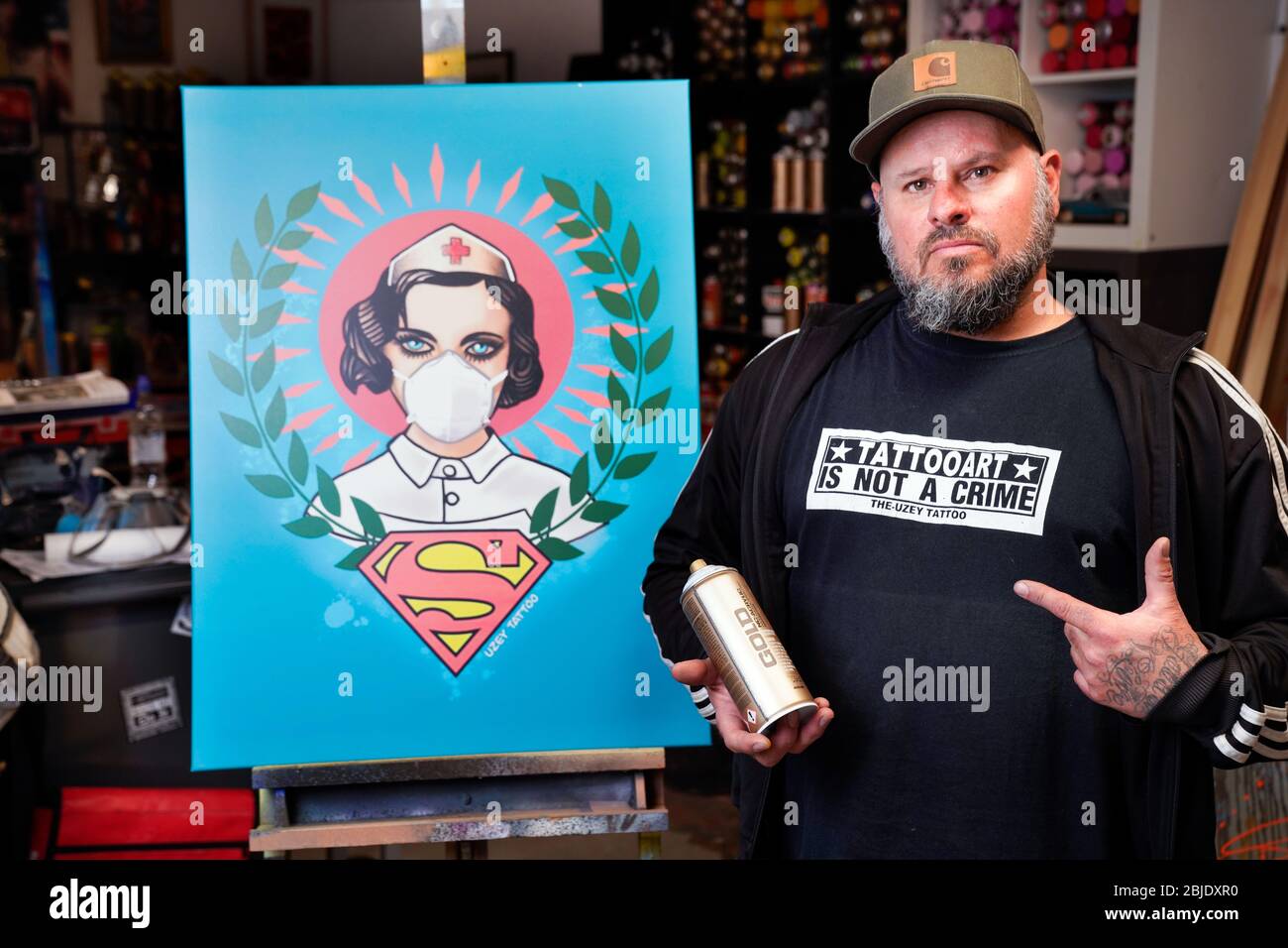 Hamm/Germany, April 29th 2020 - Corona art. Graffiti artist Kai 'Uzey' Wohlgemuth (photo in his studio) dedicated the 'Super Nurse' poster, a nurse with a face mask and superman logo, to the real heroes of the Corona crisis.  ---   Hamm, 29.4.2020 - Corona-Kunst. Das Poster „Super-Nurse“, eine Krankenschwester mit Mundschutz und Supermann-Logo, hat der Graffiti-Künstler Kai „Uzey“ Wohlgemuth (Foto in seinem Atelier) aus Hamm den echten Helden der Corona-Krise gewidmet. Stock Photo