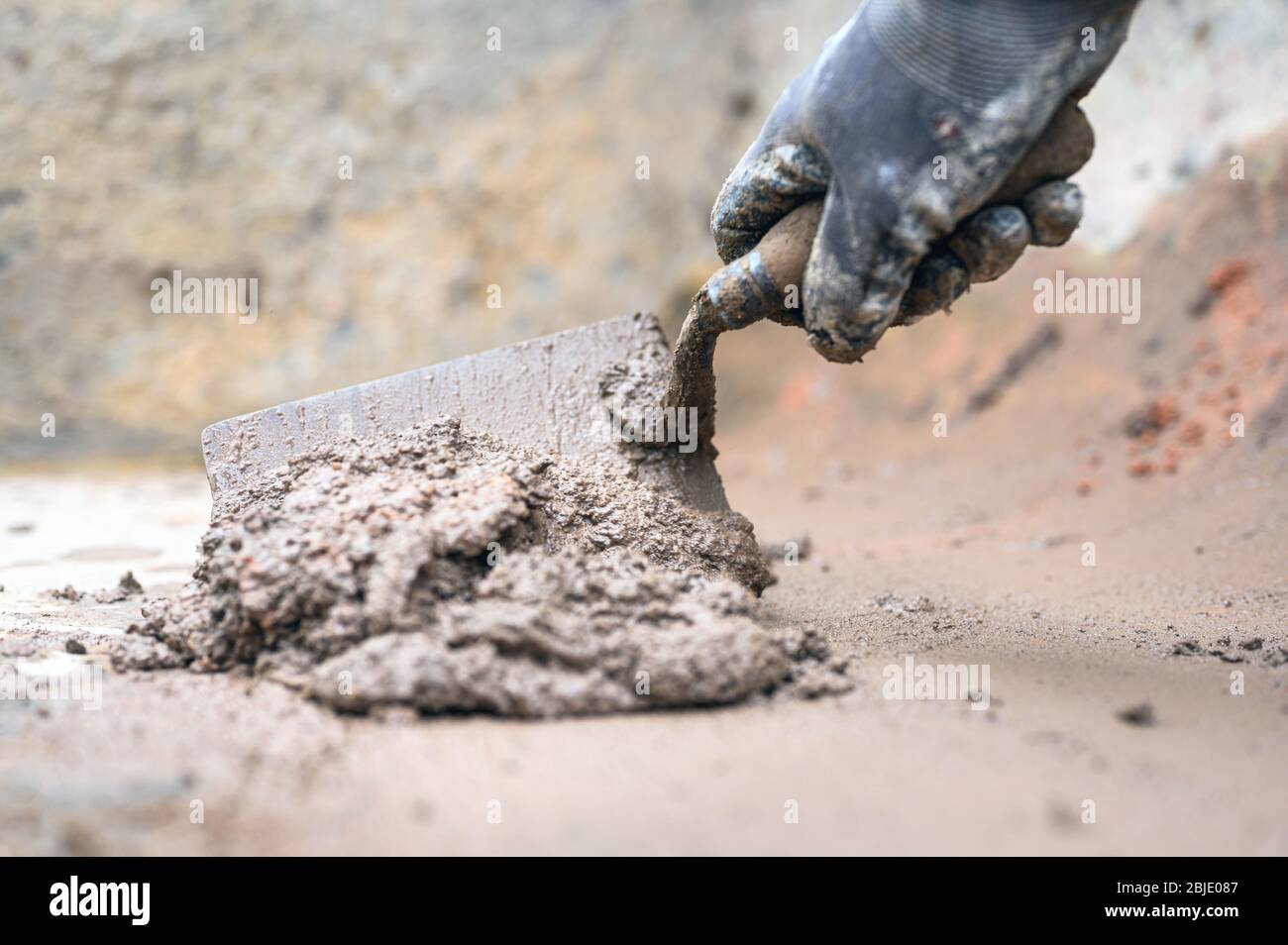 Construction worker Man hand using trowel to mix mortar Stock Photo Alamy