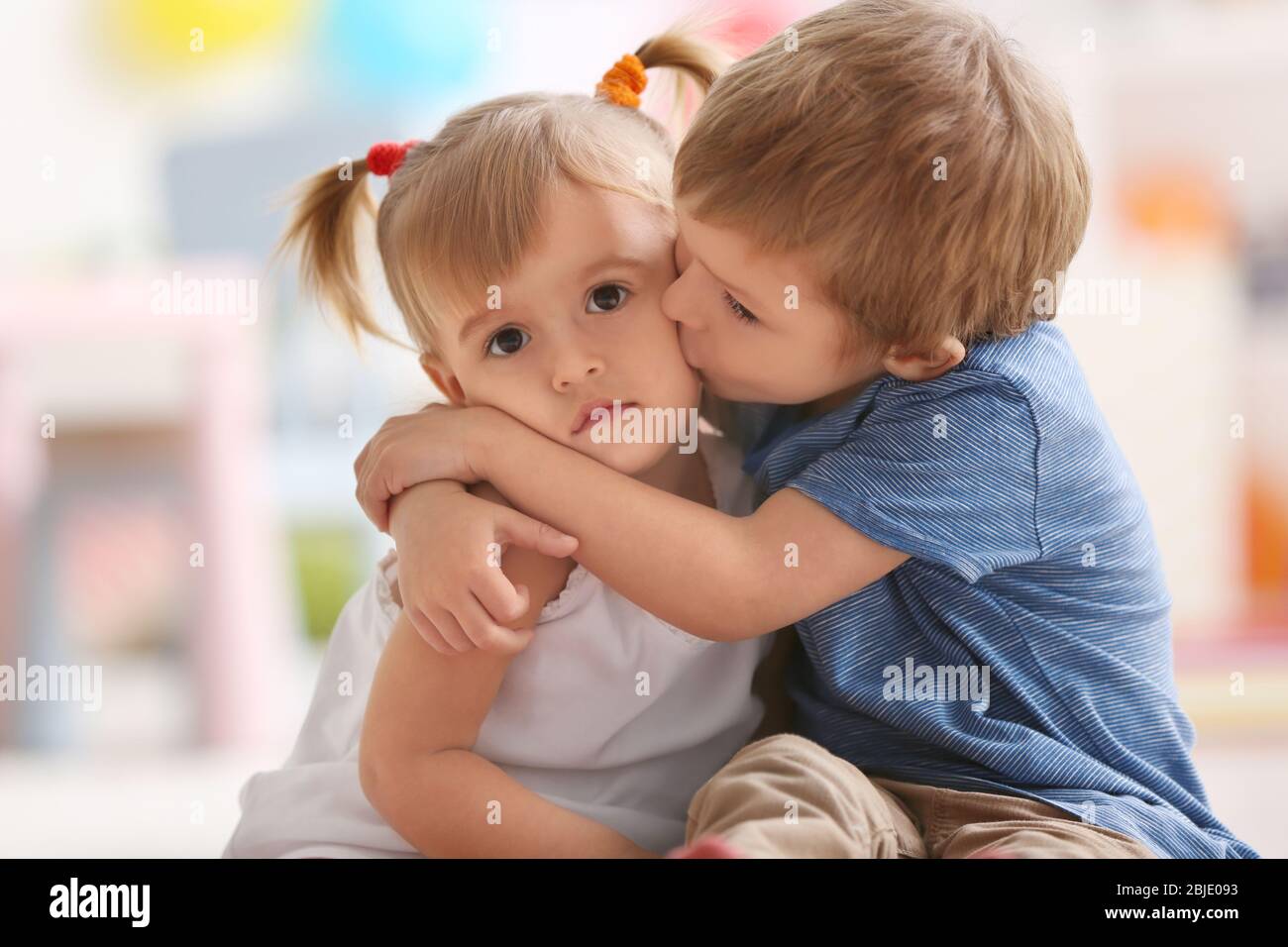 Cute little boy hugging sister at home Stock Photo Alamy